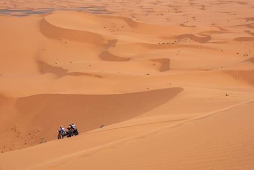 Motorbikers driving off-road in the Erg Chebbi desert near Merzouga, Morocco