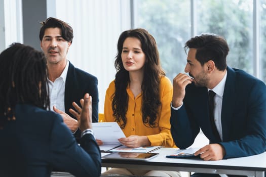 Diversity recruiters interview candidate at the bright office. A group of human resources professionals explaining an applicant for a new position. asking interviewee a question. Intellectual.