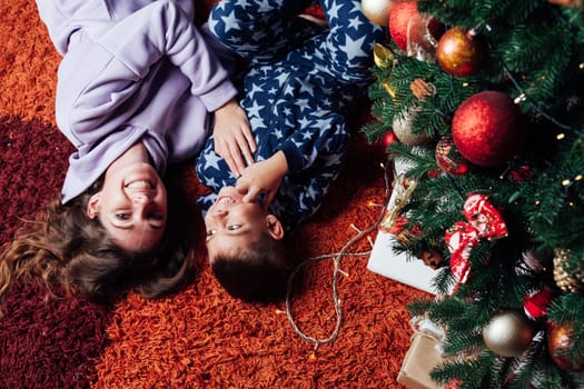 Mom with son at christmas tree for new year