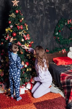 Mom with son at christmas tree for new year