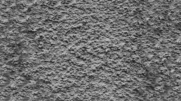 Rough texture of a gray concrete wall.