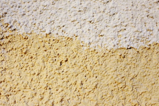 Abstract background of orange and beige paint on the wall close-up. The fong is half painted in different colors.