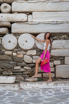 Woman with pink skirt at Frankish Castle Paroikia in Paros, Greece