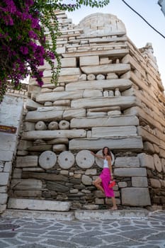 Woman with pink skirt at Frankish Castle Paroikia in Paros, Greece