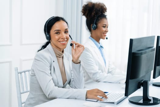 Business people wearing headset working in office to support remote customer or colleague. Call center, telemarketing, customer support agent provide service on telephone video conference call crucial