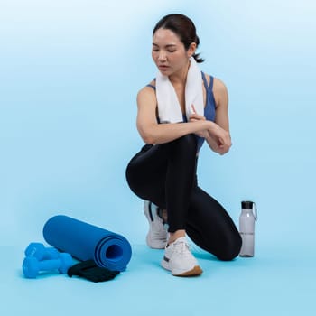 Athletic and sporty asian woman resting after intensive cardio workout training. Healthy exercising and fit body care lifestyle pursuit in studio shot isolated background. Vigorous