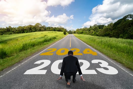 2024 New Year journey and future vision concept . Businessman traveling on highway road leading forward to happy new year celebration in beginning of 2024 for bliss and successful start .