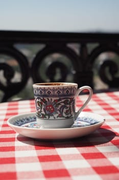 a cup of turkish coffee on table .