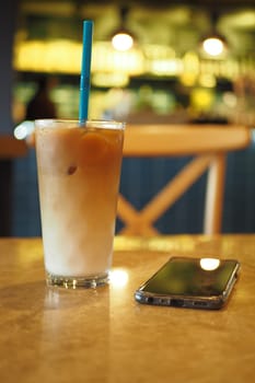 iced late in a transparent glass on cafe table outdoor ,