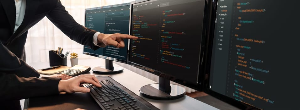 Software development team working together in office, coding script display on computer monitor. Programmer and software engineer working in tech developer company. Trailblazing