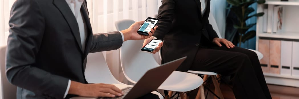 Job applicant sitting in on chair at waiting room with corridor, job seeker candidate talking, showing resume while waiting for job interview. Friendship in career opportunity concept. Trailblazing