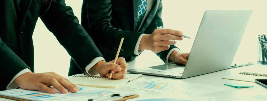 Business people in group meeting in formal attire share idea discussing report for company profit in creative workspace for start up business shot in close up view on group meeting table . Oratory .