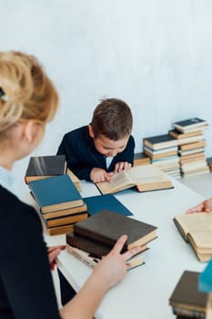 Female teacher teaching children boy and girl in school classroom