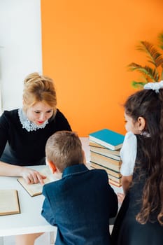 teacher teaching children in school classroom