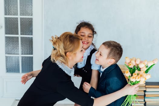 Children congratulating the teacher on the holiday