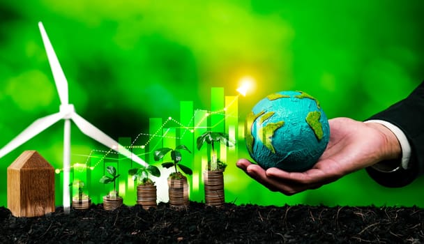 Growing coin or money stack with ESG businessman hold Earth globe symbolize eco investment with sustainable growth potential lead to profitable financial return and environmental protection. Reliance