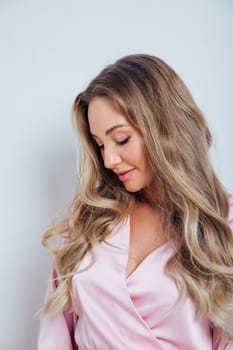 a portrait of a beautiful blonde woman in a pink dress beautiful makeup