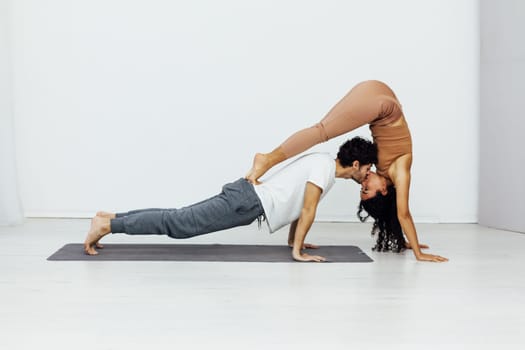 a woman and man practice yoga lotus pose stretching healthy back asana exercises