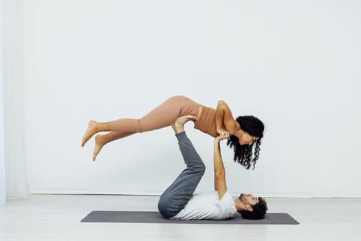 a woman and man practice yoga lotus pose stretching healthy back asana exercises