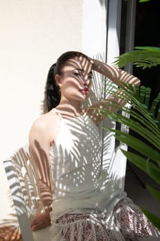 woman in the shade of palm leaves