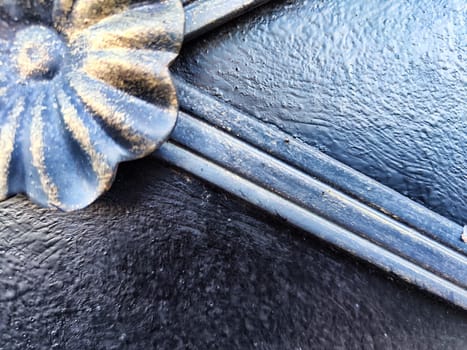 Fragment of forged metal products close-up. Beautiful flower, handmade. Abstract background, texture, pattern, frame place for text
