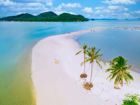 Koh Yao Yai Thailand, A couple of men and women are walking on the beach on the Island of Koh Yao Yai Thailand, with white sand and palm trees, Laem Had Beach