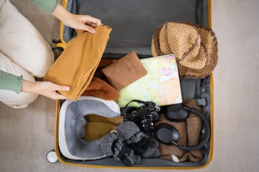 Traveler woman packing prepare stuff and outfit clothes in suitcases travel bag luggage for holiday at home, weekend, tourist, journey.