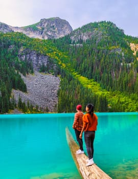 Joffre Lakes British Colombia Whistler Canada, a blue green colorful lake of Joffre Lakes National Park in Canada. A couple of Asian women and caucasian men walking at Jofre Lake BC Canada