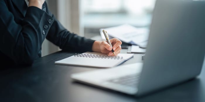 Young business woman looking at computer monitor, analyzing project statistics, marketing research results or statistics data, developing marketing strategy, working at office.