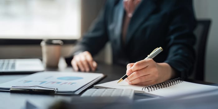 Young business woman looking at computer monitor, analyzing project statistics, marketing research results or statistics data, developing marketing strategy, working at office.