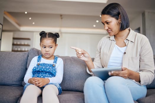 Mom, child and scolding or discipline, tablet and punishment for technology. Parent and daughter, communication and disappointed for cyberbullying, bad behaviour and frustrated for digital mistake.