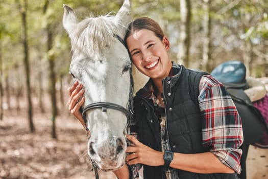 Portrait of happy woman with horse standing in trees, embrace and love for animals, pets or dressage in forest. Equestrian sport, girl jockey or rider in woods for adventure, pride and smile on face