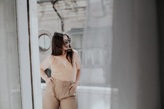 Woman in clothes on the balcony in the room