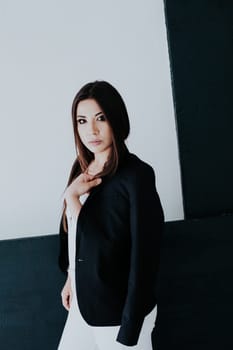 Brunette woman in black jacket on black and white