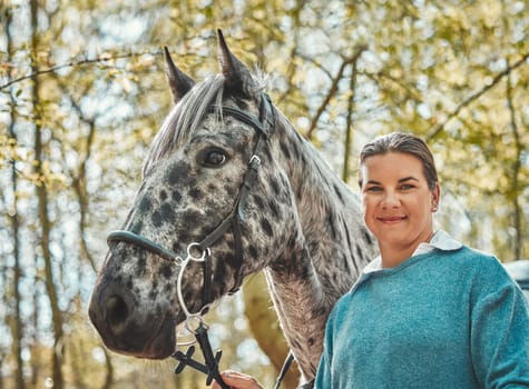 Portrait of horse with happy woman in woods, nature and love for animals, pets or dressage with trees. Equestrian sport, jockey or rider in forest for outdoor adventure, training and smile on face