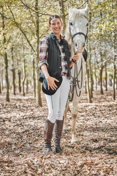 Portrait of happy woman with horse standing in forest, nature and love for animals, pets or dressage with trees. Equestrian sport, jockey or rider in woods for adventure, pride and smile on face