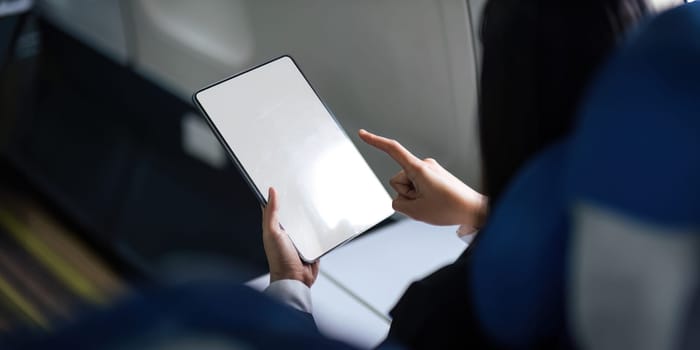 Business woman working on tablet computer. tablet vertical screen mockup.