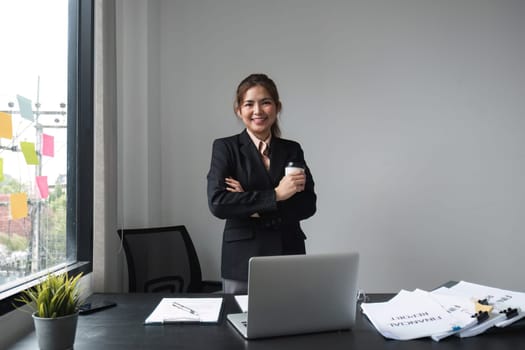 Asian businesswoman standing in office with confidence.