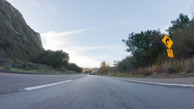 Basking in the beauty of a sunny winter day, driving on HWY 1 near Las Cruces, California offers stunning views of the picturesque coastal landscape against a backdrop of clear blue skies.