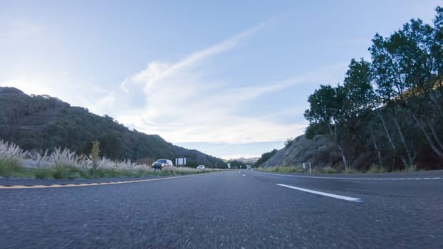 Basking in the beauty of a sunny winter day, driving on HWY 1 near Las Cruces, California offers stunning views of the picturesque coastal landscape against a backdrop of clear blue skies.