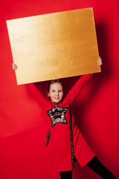 The girl holds a yellow sheet of plywood in her hands