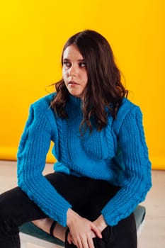 Brunette woman posing on yellow