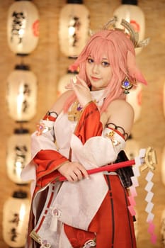 Portrait of a beautiful young woman game cosplay on japanese lantern