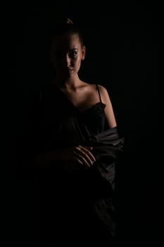 Woman in nightwear in dark room