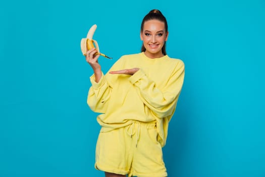 a Woman in yellow suit with open banana