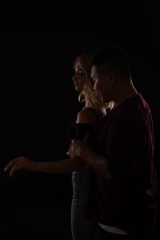 Man and woman dancers in dark