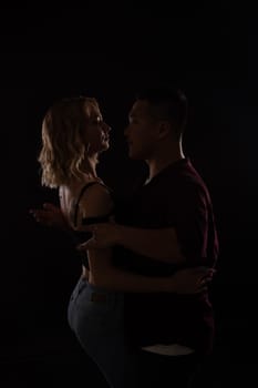 Man and woman dancers in dark