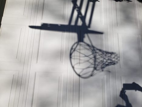 View of a Shadow of a Basketball Goal on Garage Door