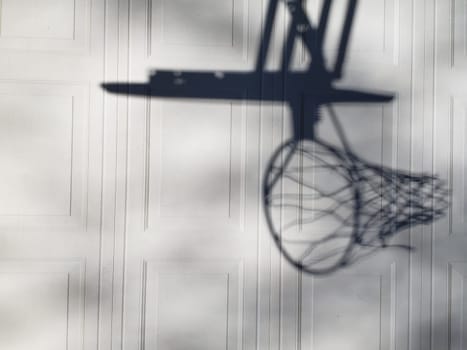 View of a Shadow of a Basketball Goal on Garage Door