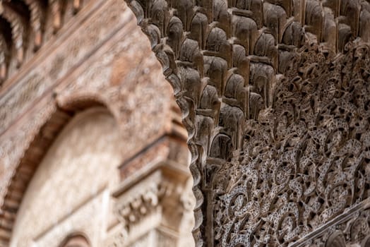 Rich decorated facade in the courtyard of a traditional madrasa, Morocco